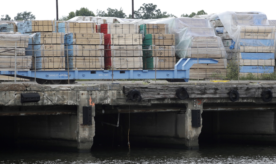 Nearly 1,770 tons of Peruvian wood, nearly all of it found to have been illegally harvested in the Amazon rainforest, sits under tarps dockside at The Port of Houston. It was denied entry by U.S. Customs in October 2015 and was destroyed more than a year later in a non-fault administrative settlement. At least one importer fell under federal criminal investigation. The lumber is Exhibit A in the fight to preserve tropical forests, a vital buffer against climate change. (AP Photo/David J.