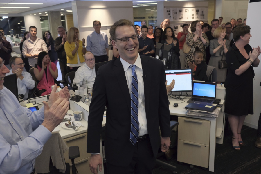 Members of the Washington Post staff congratulate David Fahrenthold, center, Monday upon learning that he won the Pulitzer Prize for national reporting.