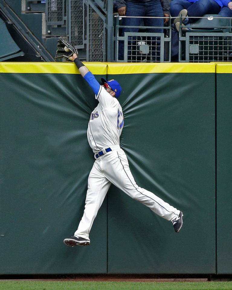 Seattle Mariners center fielder Mitch Haniger makes a leaping catch at the wall to rob Texas Rangers' Joey Gallo of a two-run home run with the score tied in the eighth inning, Sunday, April 16, 2017, in Seattle. (AP Photo/Ted S.
