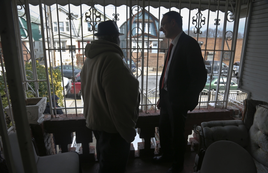 Raymond Murray gets a visit from his lawyer, Robert Seewald, right, Feb. 1 at his home in New York. Murray is the victim of deed theft, a foreclosure fraud where older people are mostly the target.