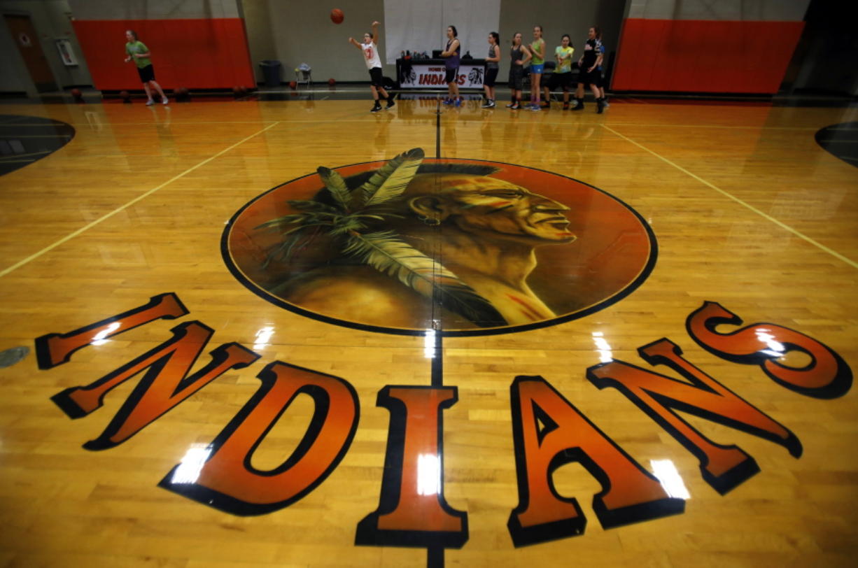 The mascot of the Mohawk High School Indians is displayed on the floor of the school&#039;s gym in Marcola, Ore. The Marcola School Board voted Wednesday to drop the Indians nickname and mascot at Mohawk High School.