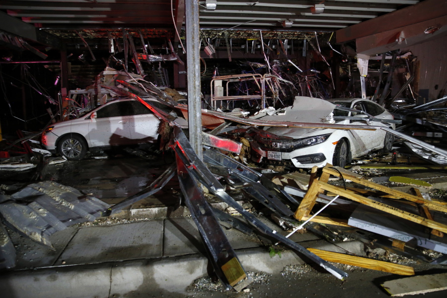 Cars and trucks are damaged as the walls blew out of the Interstate 20 Dodge dealership after a tornado hit Saturday night near Canton, Texas.