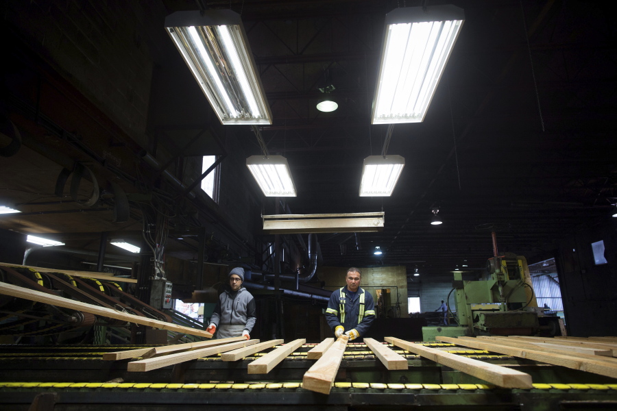 Workers sort lumber at the Partap Forest Products mill in Maple Ridge, British Columbia on Tuesday.