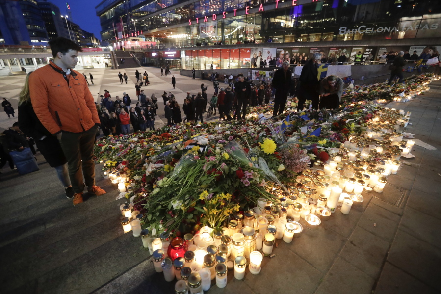 Candles and flowers placed at the Sergels Torg to commemorate the victims of last Friday&#039;s terror attack in Stockholm, Sweden on Sunday. A hijacked truck was driven into a crowd of pedestrians and crashed into a department store on Friday.