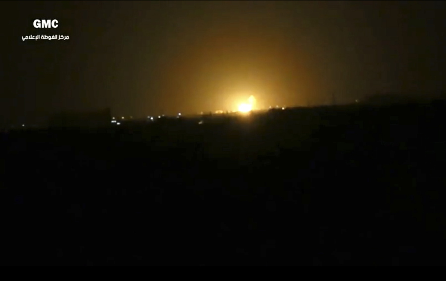 This image from video provided by a Syrian anti-government group shows flames rising after an explosion Thursday near an airport west of Damascus, Syria.