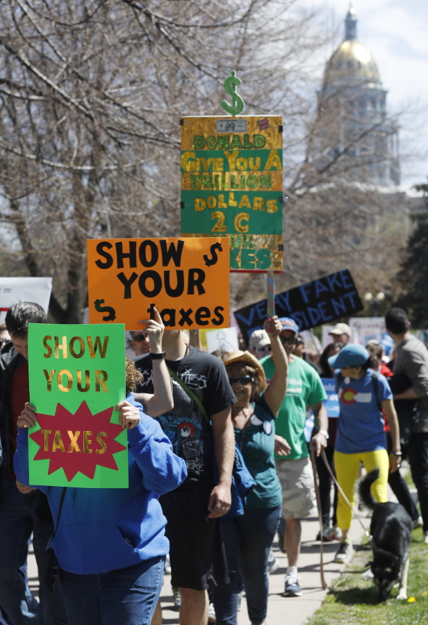 Anti-Donald Trump protesters march during a rally in downtown Denver on Saturday, April 15, 2017. It was one of dozens in cities nationwide to call on Trump to release his tax returns, saying Americans deserve to know about his business ties and potential conflicts of interest.