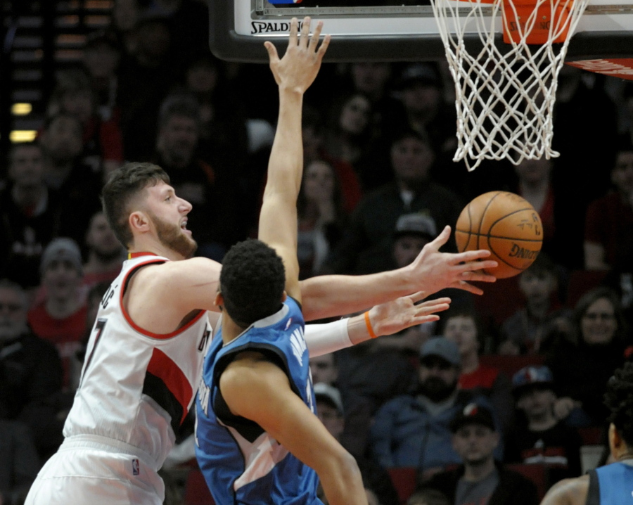 FILE - In this March 25, 2017, file photo, Portland Trail Blazers center Jusuf Nurkic drives to the basket on Minnesota Timberwolves center Karl-Anthony Towns during an NBA basketball game in Portland, Ore. The Blazers upgraded Nurkic to doubtful for Game 3 of their playoff series against the Golden State Warriors. The Warriors have a 2-0 lead in the series, which shifts to Portland on Saturday night, April 22. Nurkic missed the final seven games of the regular season and the first two playoff games at Golden State because of a nondisplaced fracture in his right leg.