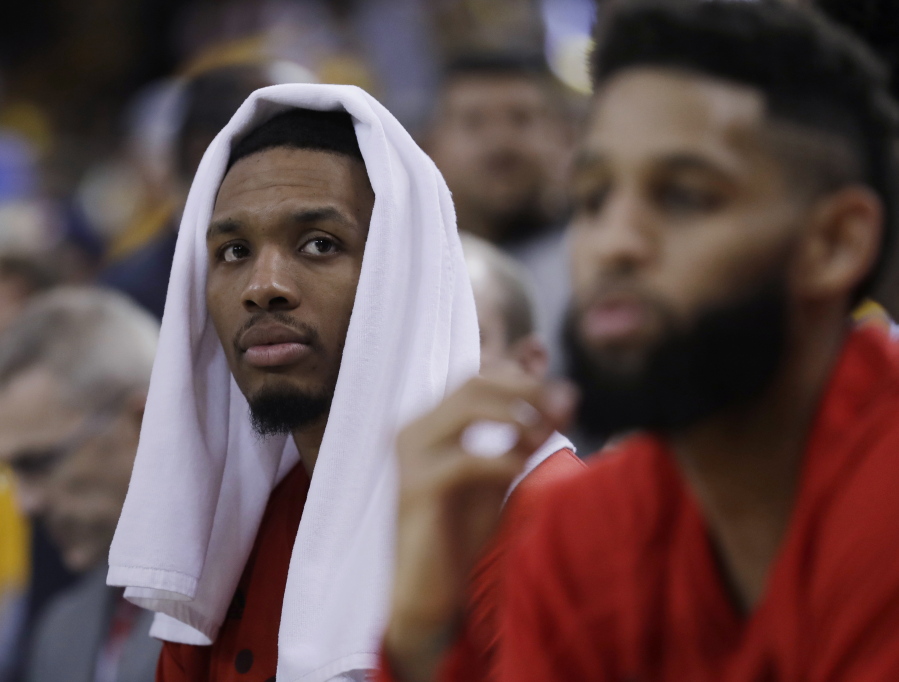 Portland Trail Blazers&#039; Damian Lillard, left, and Allen Crabbe watch from the bench in the closing minutes of the team&#039;s 110-81 loss to the Golden State Warriors ipn Game 2 of a first-round NBA basketball playoff series Wednesday, April 19, 2017, in Oakland, Calif.