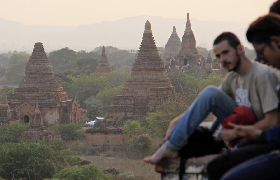 In this Monday, March 13, 2017 photo, tourists gather on Shwesandaw Pagoda to watch the sunset over thousands of pagodas in the ancient Myanmar city of Bagan.  The city is home to the largest concentration of Buddhist temples, stupas and monuments in the world, most of which were built in the 11th and 12th centuries.