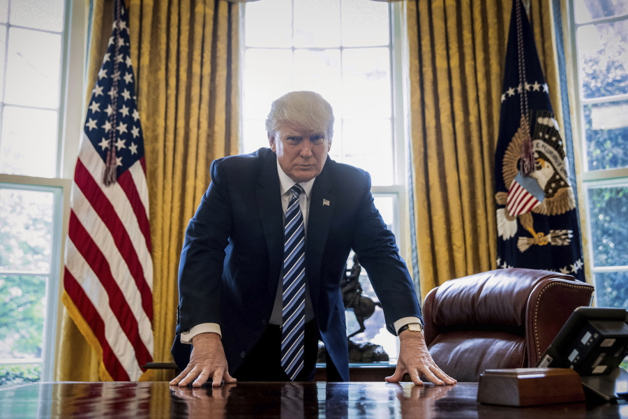 President Donald Trump poses for a portrait April 21 in the Oval Office in Washington after an interview with The Associated Press.