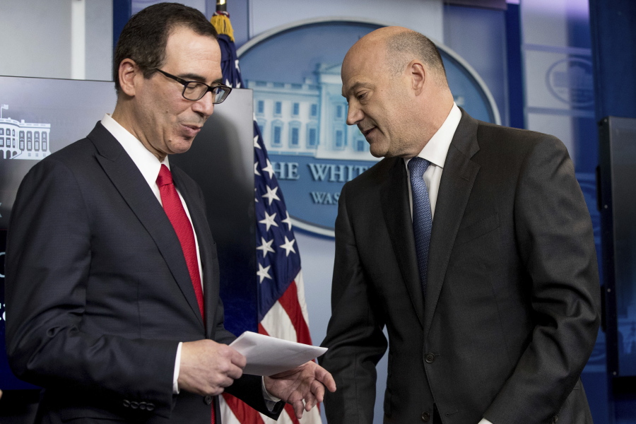 National Economic Director Gary Cohn, right, yields the podium to Treasury Secretary Steve Mnuchin in the briefing room of the White House, in Washington, Wednesday, where they discussed President Donald Trump tax proposals.