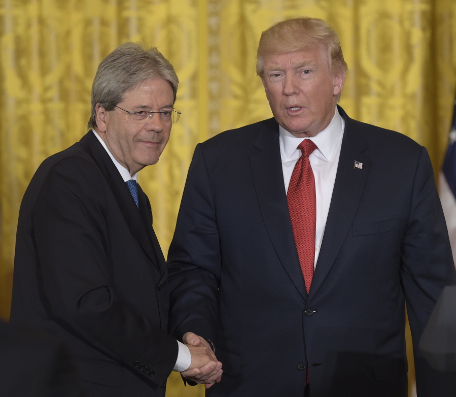 Italian Prime Minister Paolo Gentiloni, left, shakes hands with President Donald Trump following their news conference Thursday at the White House.