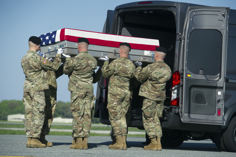 An Army carry team places a transfer case containing the remains of Army Sgt. Cameron Thomas, 23, of Kettering, Ohio, into the transfer vehicle, Friday at Dover Air Force Base, Del. Thomas and Sgt. Joshua P. Rodgers, 22, of Bloomington, Ill, killed during a raid on an Islamic State compound in eastern Afghanistan, may have died as a result of friendly fire during the opening minutes of the fierce, three-hour firefight, the Pentagon said Friday.