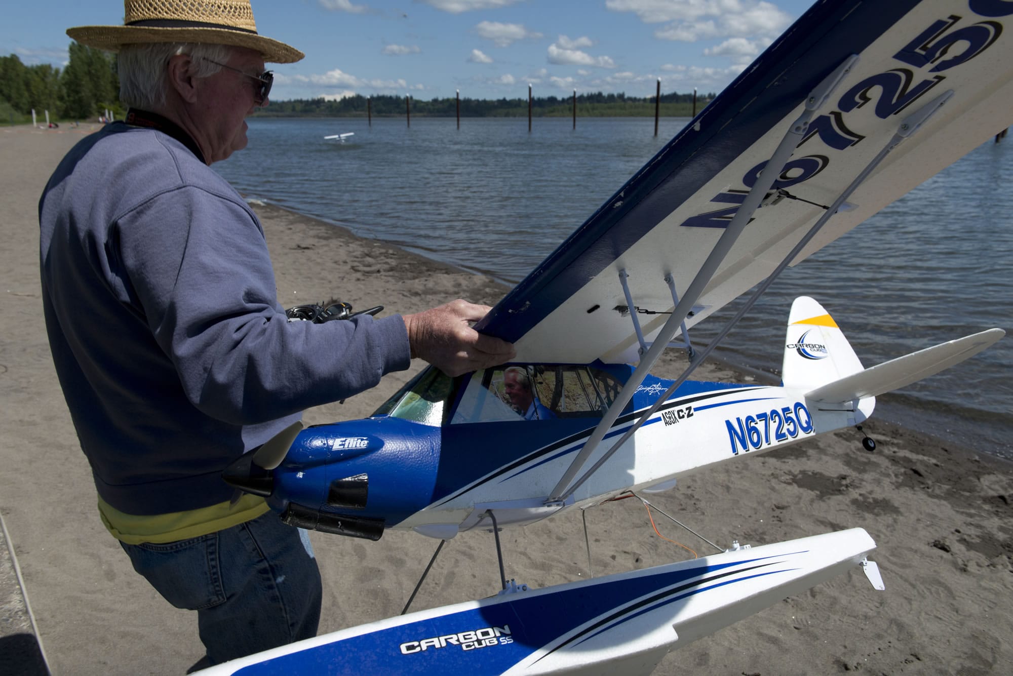 Jeff McIlvenna, of Vancouver, owns 52 RC planes including this one with his own photo "piloting" the plane at the Clark Co. Radio Control Society's 8th annual Wet Wings event at Vancouver Lake Park on Sunday.