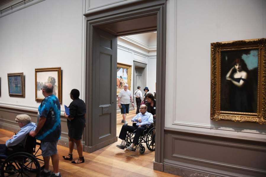 Participants in the &#039;Just Us at the National Gallery of Art&#039; gather to view a painting by Claude Monet. The program is for people with memory loss and their caregivers.