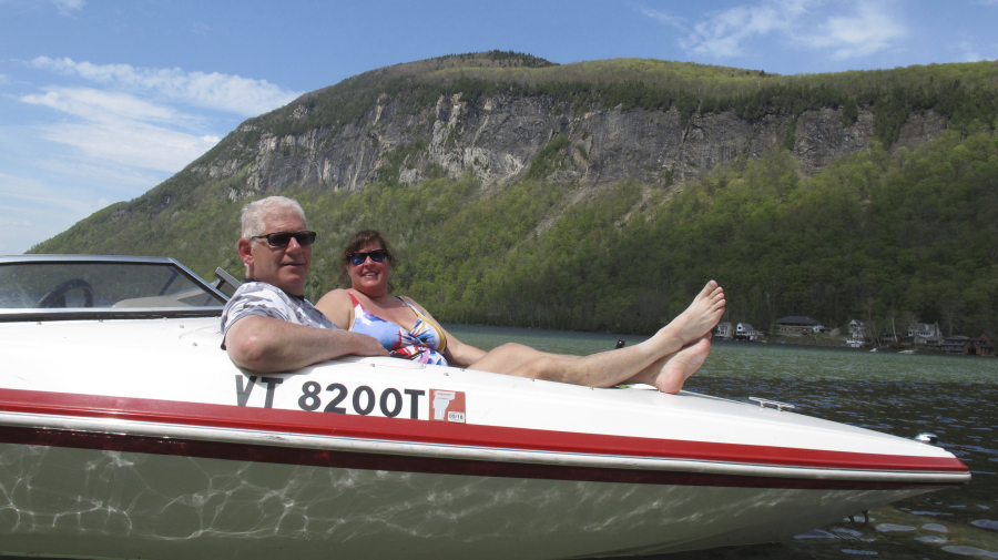Kurt and Alison Harrison relax in their boat Thursday on Lake Willoughby in Westmore, Vt.
