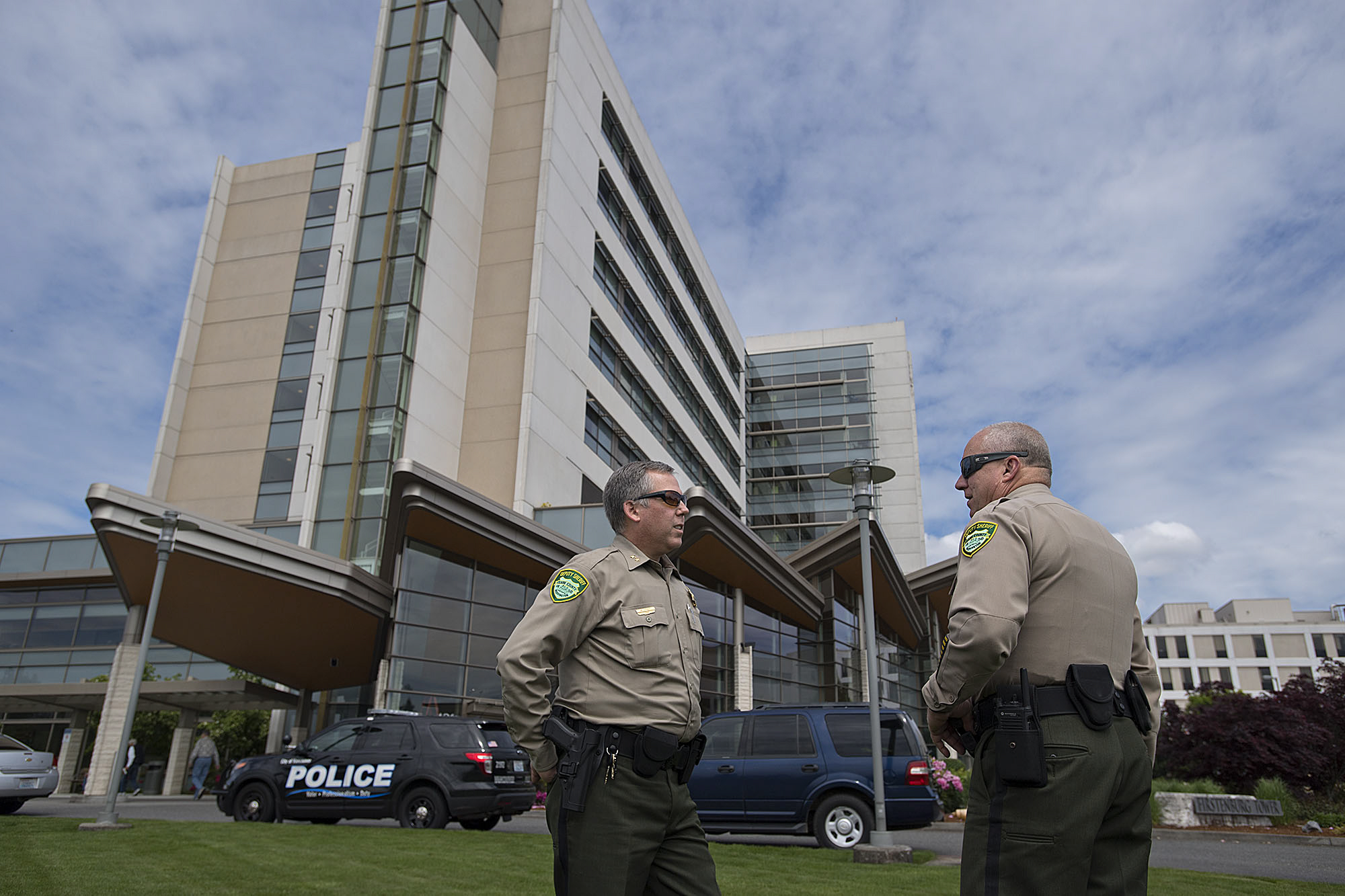 Undersheriff Mike Cooke of the Clark County Sheriff's Office, left, talks with Chief Criminal Deputy John Chapman as they respond to the scene of a shooting at PeaceHealth Southwest Medical Center on Thursday morning.