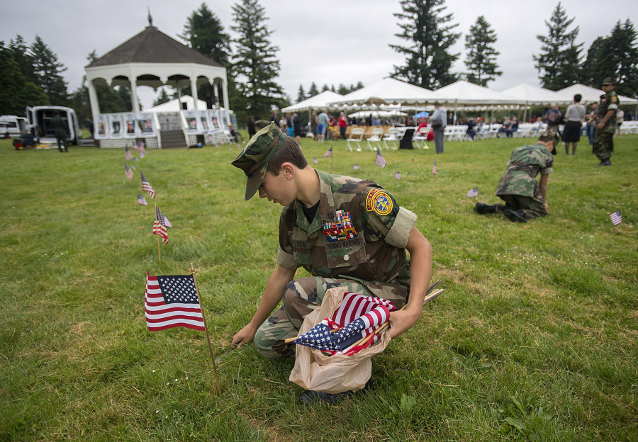 Sgt. Hunter Mallicoat, 14, of the Lewis & Clark Young Marines helps prepare Fort Vancouver National Historic Site for the annual Memorial Day Observance on Monday morning.
