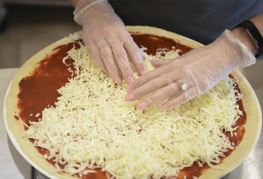 Chairwoman and interim CEO of Papa Murphy&#039;s Jean Birch makes a pizza at a franchise at East Mill Plain Boulevard in Vancouver. The company posted a year-over-year $5.4 million loss for first fiscal quarter 2017.