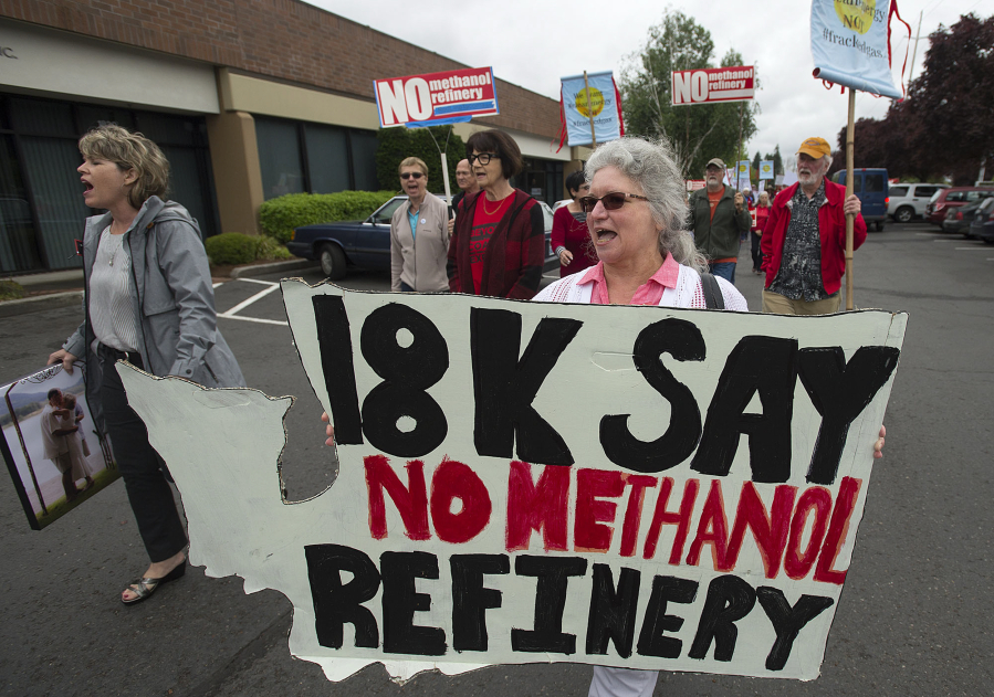 Longview resident Diane Dick, center, walks in a crowd of demonstrators to toward the Washington Department of Ecology’s office in Orchards. The crowd opposed the NW Innovation Works methanol refinery proposed for Kalama. If approved, it would be the largest of its kind in the world.