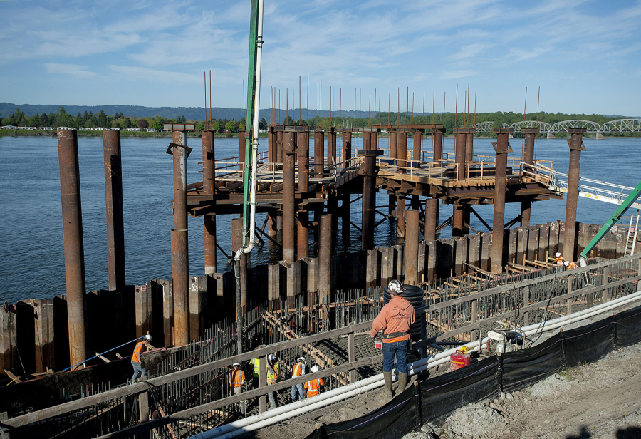 Workers pour concrete for the new Grant Street Pier at the Waterfront Vancouver on Thursday morning. The pier will be supported by cables and is expected to open next spring.