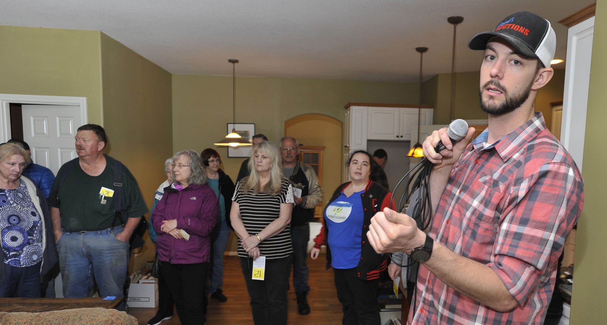 Estate Sale auctioneer Wade Boyd calls for bids on household items at a home in Vancouver in April.