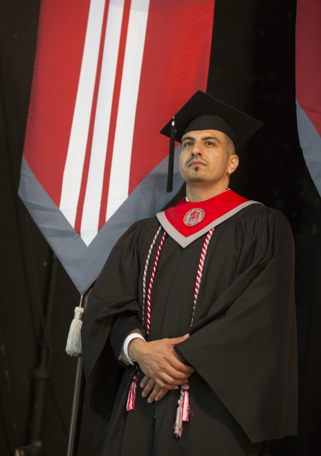 Julian Rivas carried in a banner during graduation from Washington State University&#039;s Vancouver campus held at a ceremony Friday at the Sunlight Supply Amphitheater in Ridgefield. Rivas was recognized at the ceremony for both his personal story and excellent grade point average. (Photo by Randy L.