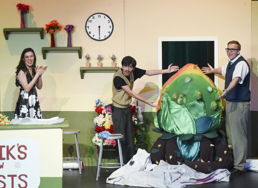 Woodland High School’s “Little Shop of Horrors” will be the school’s first musical with live accompaniment in 20 years. Emma Vande Krol, from left, Austin Matthiesen and Mason Hubbard unveil the smaller of two Audrey II puppets, inside which Evelyn Roehn works as the puppeteer.