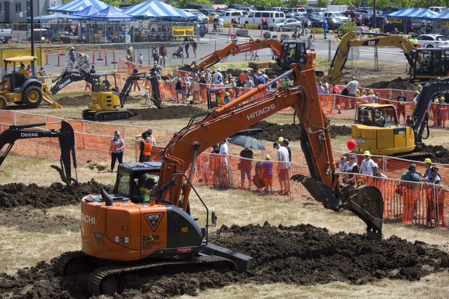 Crowds watch heavy equipment at work at Dozer Day at the Clark County Fairgrounds in Sunday. The annual event sees up to 20,000 guests each year.
