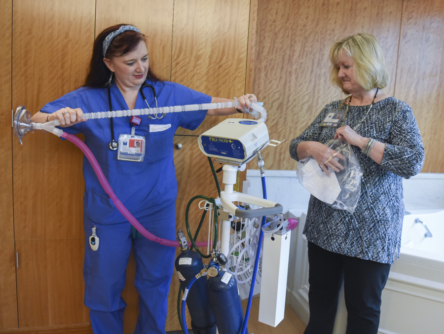 Registered nurse Regina Kaiser, left, and clinical nurse specialist Shelora Mangan set up a nitrous oxide machine in a labor and delivery room Thursday at Legacy Salmon Creek Medical Center. About a month ago, the hospital began offering the nitrous oxide — a 50-50 mix with oxygen — as a form of pain relief to women in labor.