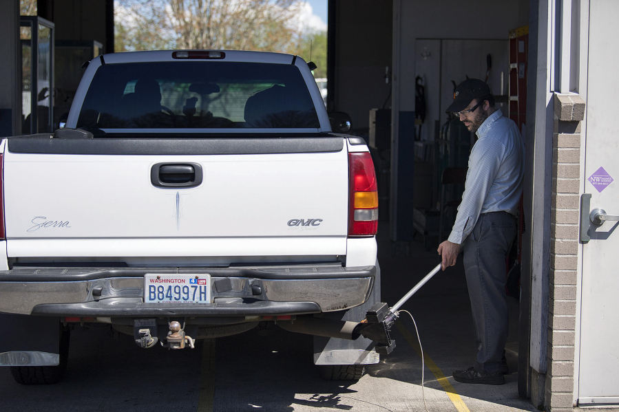 Gabriel Engel tests the emissions of a diesel truck at the Washington State Emission Inspection Station in Vancouver. The Salmon Creek site is scheduled to close in early June. All vehicle smog testing will be done in east Vancouver.