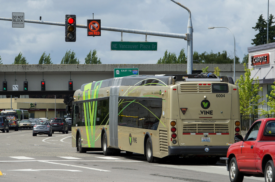 A Vine bus gets an early start through the intersection of Northeast Vancouver Plaza Drive and Thurston Way in Vancouver thanks to a queue-jump signal installed at the intersection. The signal gives the bus a 10-second head start over other cars stopped at the light.