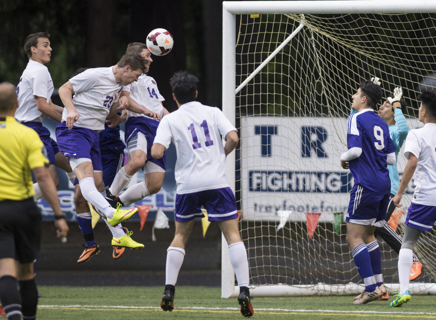 Columbia Riverís Ryan Connop (23), heads the ball into the goal in what was initially thought to be the fourth goal for Columbia River during overtime in the first round of the 2A state playoffs against Highline at the Kiggins Bowl in Vancouver, Tuesday May 16, 2017.