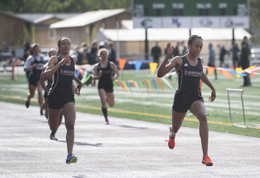Unionís Jaiílyn Merriweather, left, crosses the finish line in second in the 4A girls 200 meters while her twin sister, Daiílyn Merriweather, takes first during the second day of the 3A-4A District track meet at McKenzie Stadium, Thursday May 11, 2017.