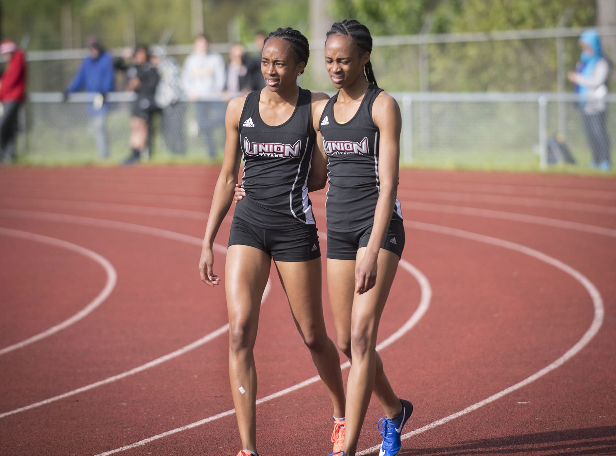 Union twins Dai’lyn Merriweather, left, and Jai’lyn Merriweather wrap their arms around each other after taking first and second in the 4A girls 200 meters during the second day of the 3A-4A District track meet at McKenzie Stadium, Thursday May 11, 2017.