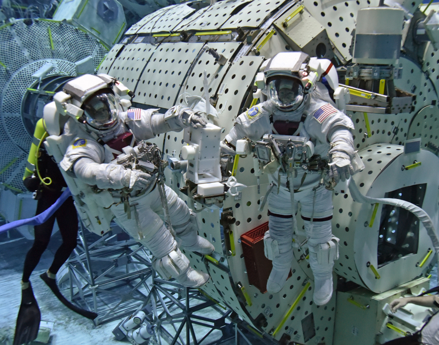 Astronauts Anne McClain, left, and Mike Barratt train for a spacewalk in NASA’s neutral buoyancy tank, which simulates zero gravity.