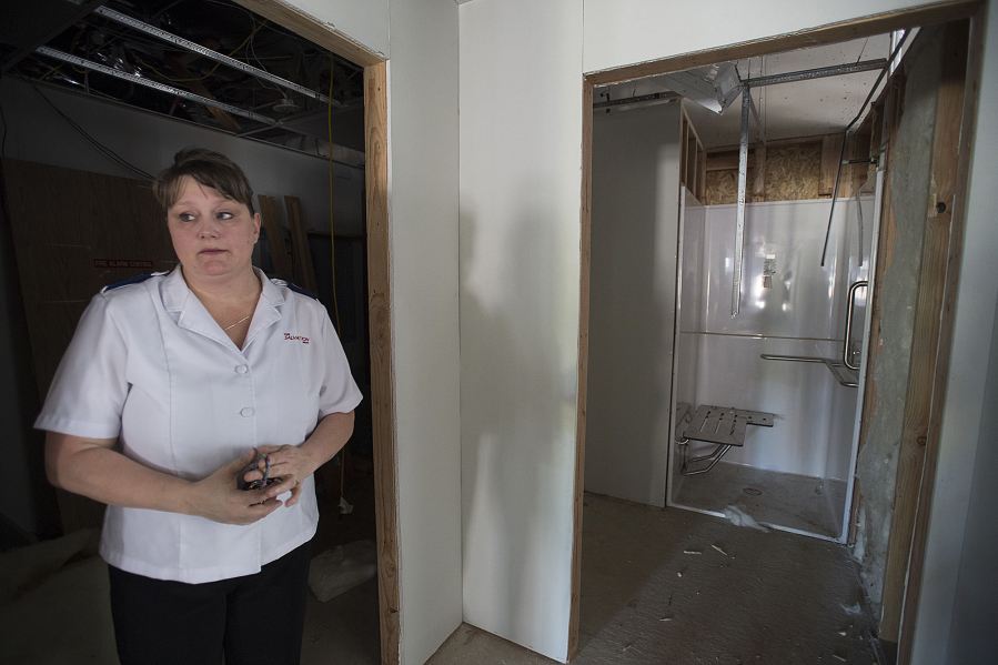 Ministry Leader Samantha Wheeler talks Tuesday morning about the shower that will be available in the new Washougal Salvation Army. “People are coming in every day asking, ‘When is it going to be open?’” she said.