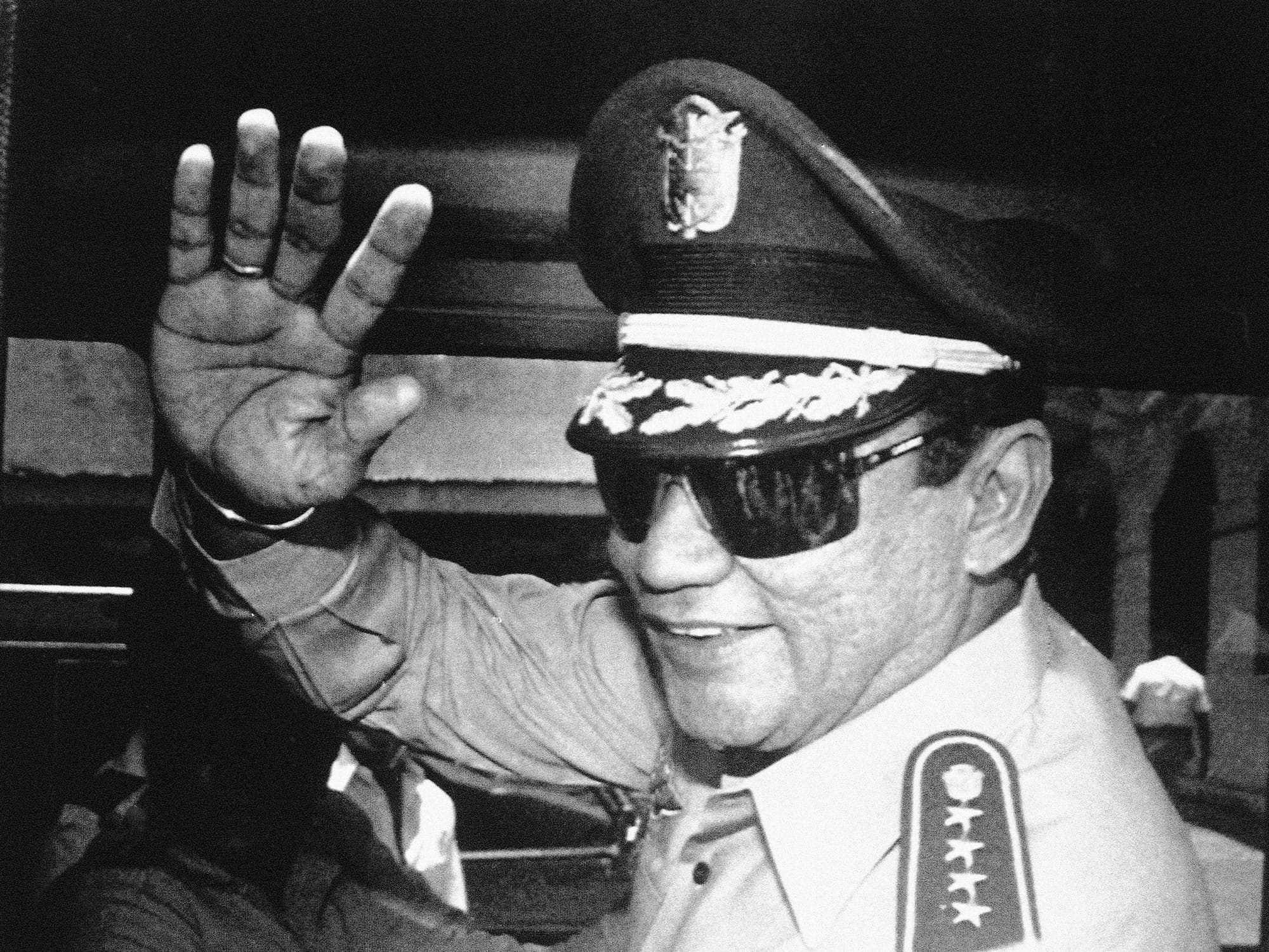 In this Aug. 31, 1989 file photo, Gen. Manuel Antonio Noriega waves to newsmen after a state council meeting, at the presidential palace in Panama City, where they announced the new president of the republic. Panama's ex-dictator Noriega died Monday, May 29, 2017, in a hospital in Panama City. He was 83.