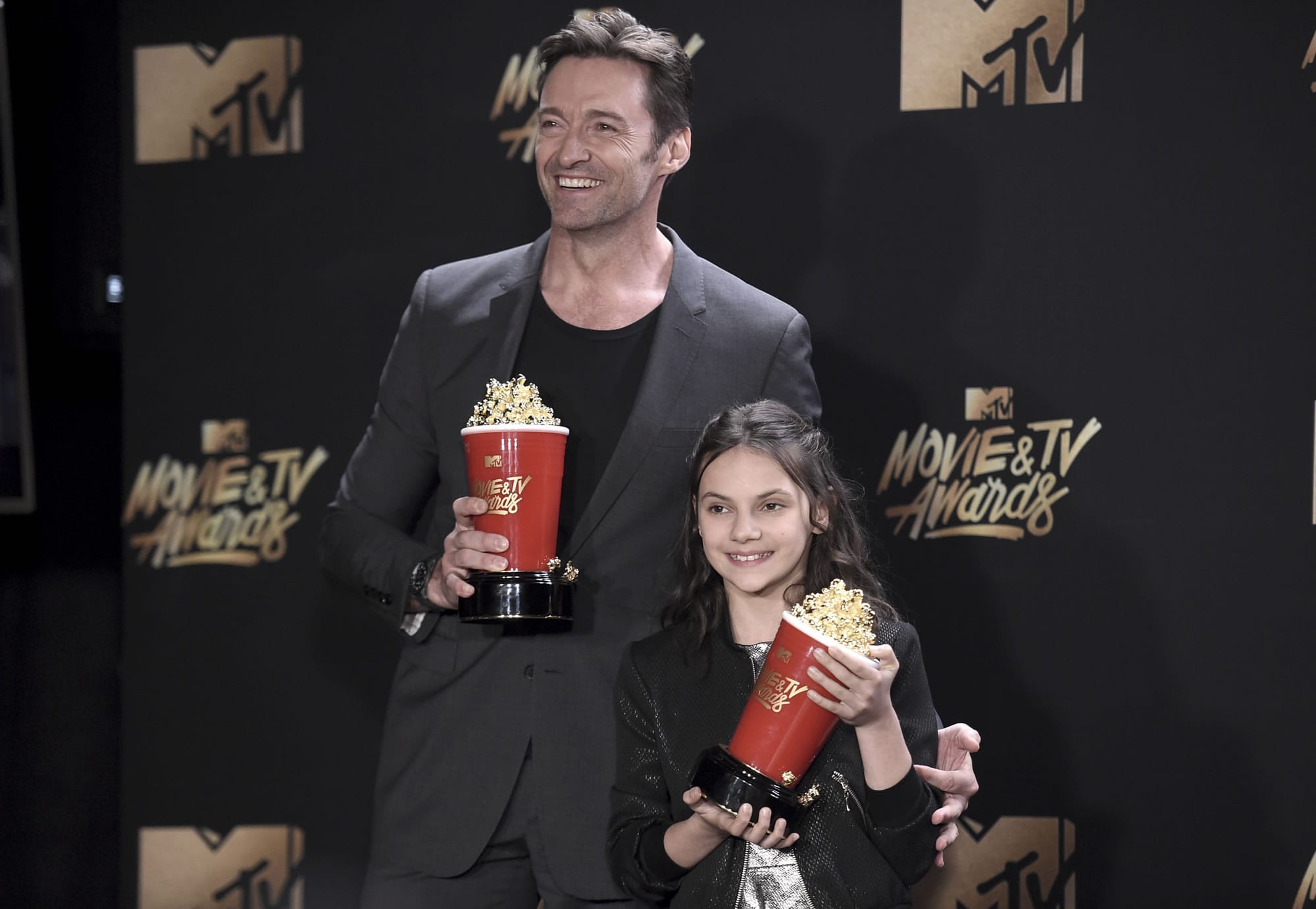 Hugh Jackman, left, and Dafne Keen pose with their awards for best duo for "Logan" in the press room at the MTV Movie and TV Awards at the Shrine Auditorium on Sunday, May 7, 2017, in Los Angeles.