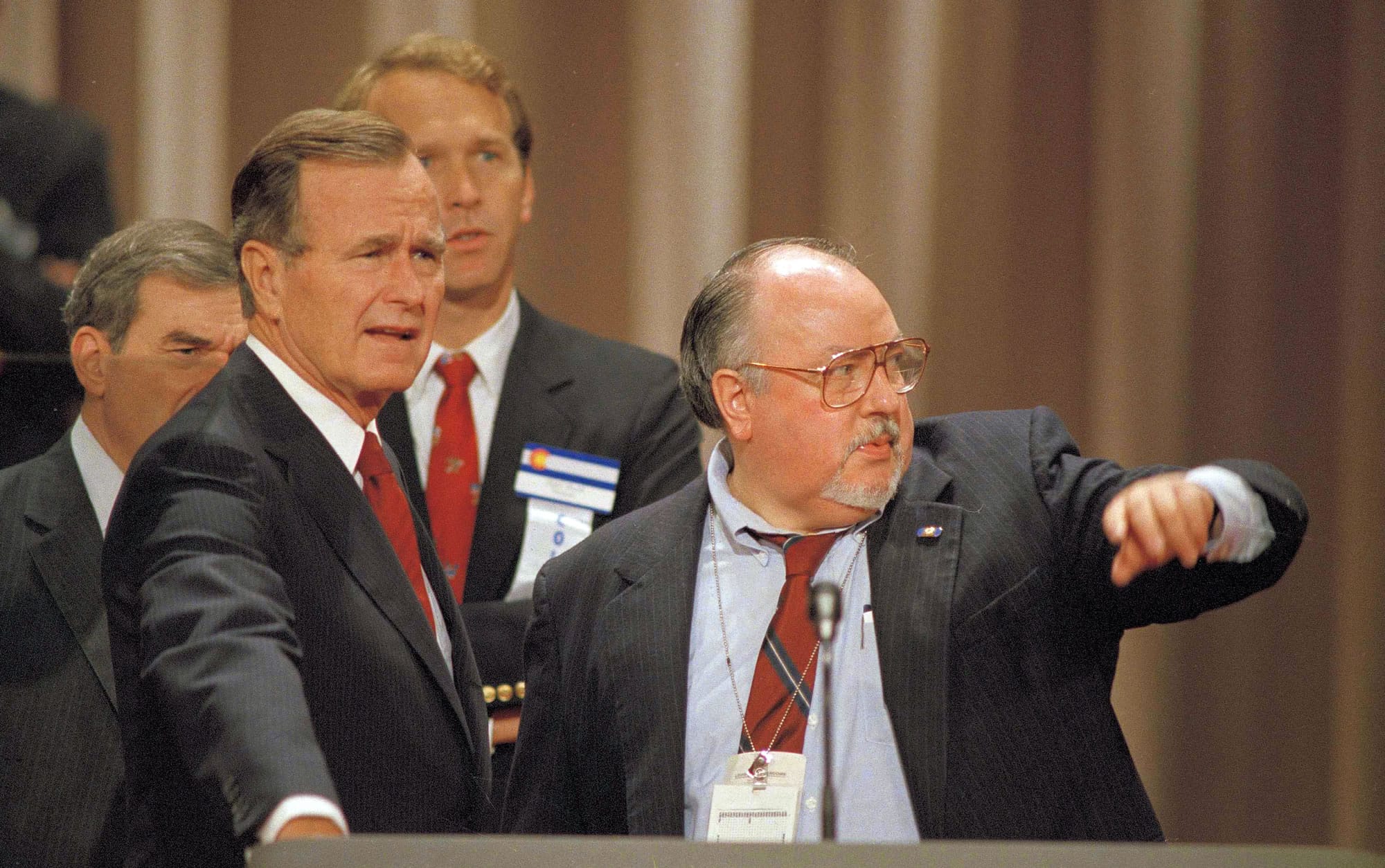 FILE - In this Aug. 17, 1988 file photo, Vice President George H.W. Bush, left, gets some advice from his media advisor, Roger Ailes, right, as they stand behind the podium at the Superdome in New Orleans, La., prior to the start of the Republican National Convention.  Fox News said on Thursday, May 18, 2017, that Ailes has died. He was 77.