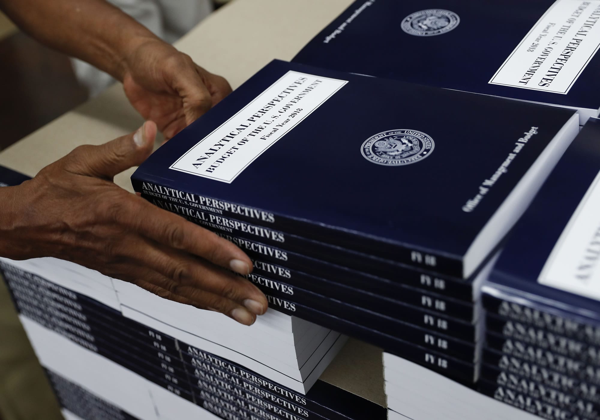 In this photo taken May 19, 2017, a GPO worker stacks copies of "Analytical Perspectives Budget of the U.S. Government Fiscal Year 2018" onto a pallet at the U.S. Government Publishing Office's (GPO) plant in Washington.