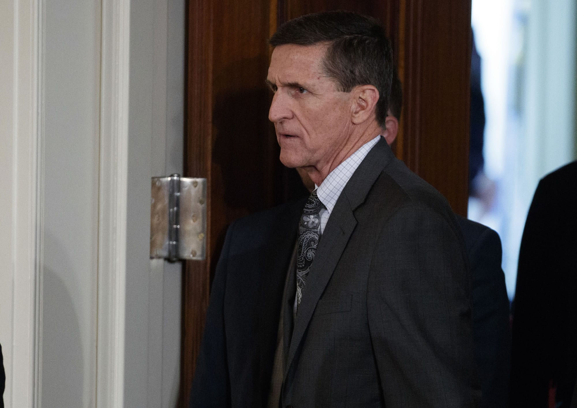 FILE - In this Feb. 13, 2017 file photo, Mike Flynn arrives for a news conference in the East Room of the White House in Washington. The former national security adviser will invoke his Fifth Amendment protection against self-incrimination on Monday, May 22, 2017, as he notifies the Senate Intelligence committee that he will not comply with a subpoena seeking documents.