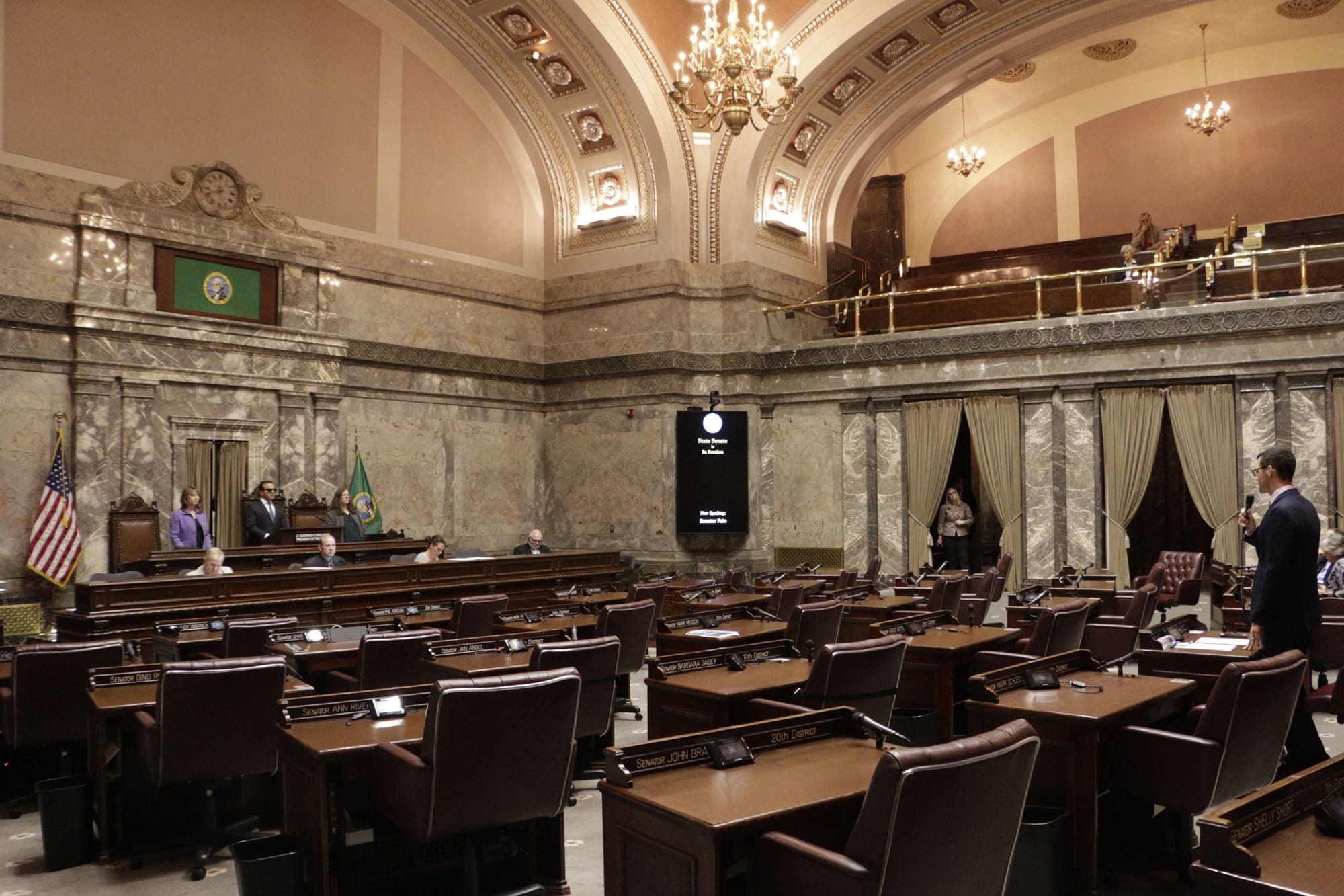 Republican Sen. Joe Fain, far right of frame, speaks in a mostly empty Senate chamber during adjournment of a 30-day special legislative session on Tuesday in Olympia. Gov. Jay Inslee immediately called the Legislature back for a second overtime session so that lawmakers can complete their work on the state budget.