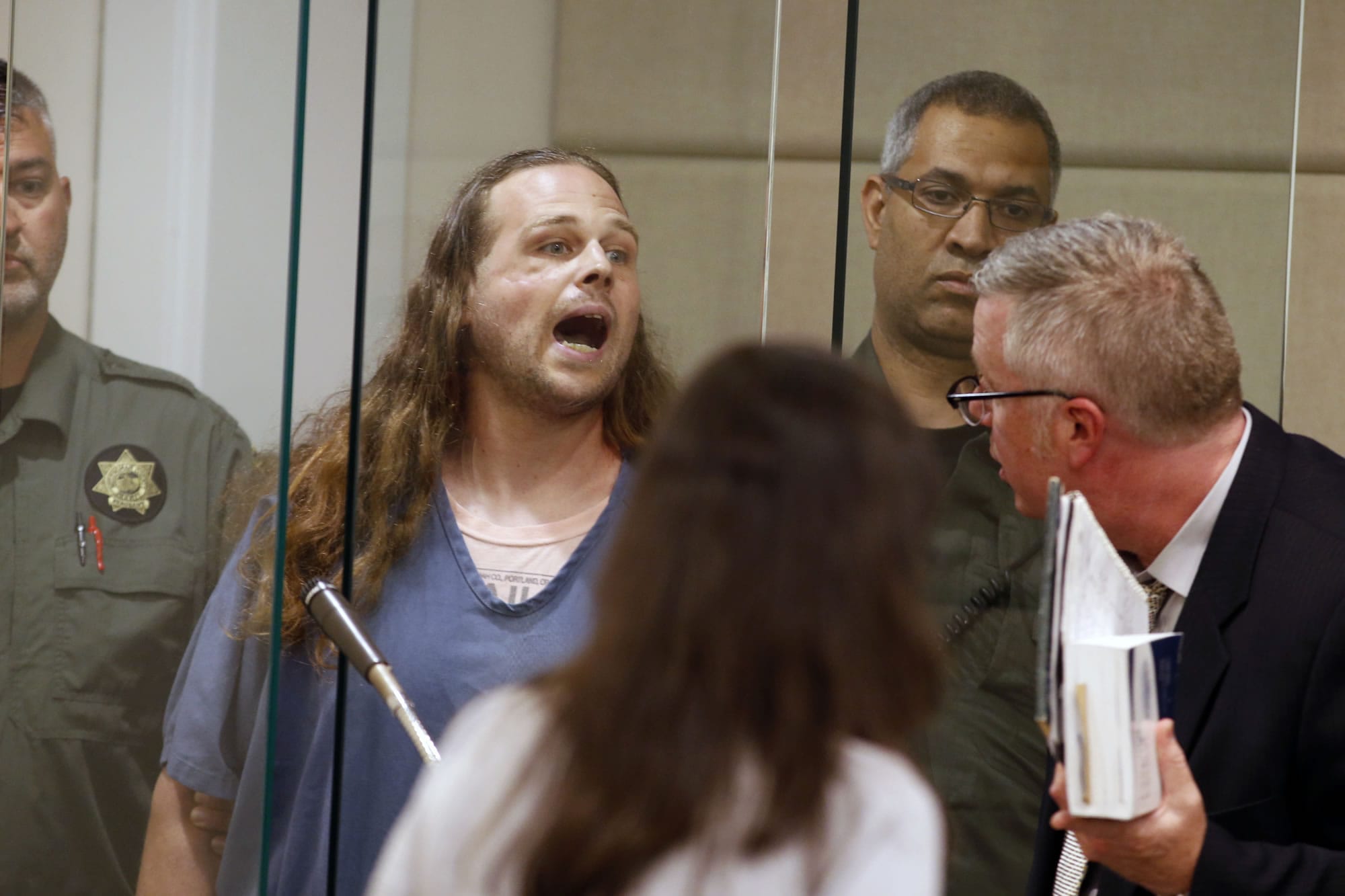Jeremy Joseph Christian shouts as he is arraigned in Multnomah County Circuit Court in Portland, Ore., Tuesday, May 30, 2017. Authorities say Christian started verbally abusing two young women, including one wearing a hijab. When three men on the train intervened, police say, Christian attacked them, killing two and wounding one.