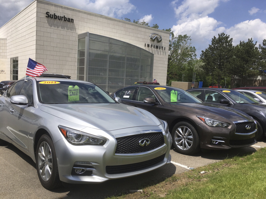 Used Infiniti Q50 luxury sedans await buyers at a dealership in the Detroit suburb of Novi, Mich.