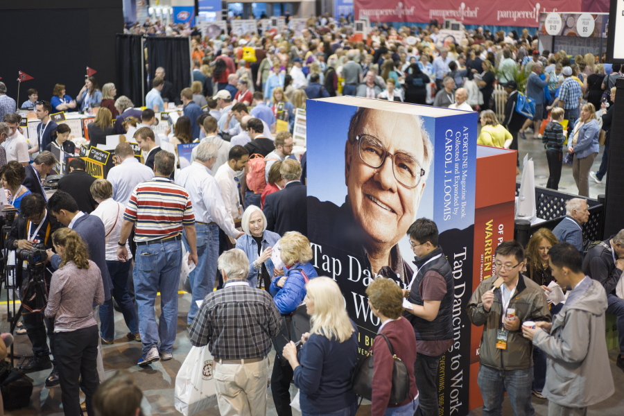 A image of Warren Buffett towers over Berkshire Hathaway shareholders as they visit and shop at company subsidiaries in Omaha, Neb., Friday, at the Berkshire Hathaway shareholders meeting. More than 30,000 people are expected to attend the annual meeting, and participate in company-sponsored activities, though the main attraction is CEO Warren Buffett and Vice Chairman Charlie Munger&#039;s Q&amp;A session on Saturday.