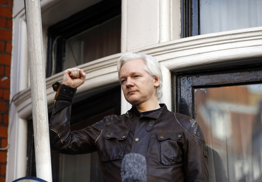 Julian Assange greets supporters Friday outside the Ecuadorian embassy in London. Sweden’s top prosecutor says she is dropping an investigation into a rape claim against WikiLeaks founder Julian Assange after almost seven years. Assange took refuge in Ecuador’s embassy in London in 2012 to escape extradition to Sweden to answer questions about sex-crime allegations from two women.