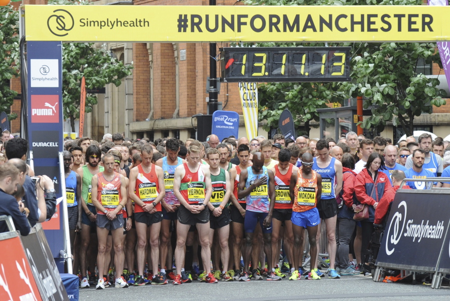 Runners observe a minute of silence before the start of the Great Manchester Run on Sunday in central Manchester, England. More than 20 people were killed in an explosion following a Ariana Grande concert May 22 at the Manchester Arena.