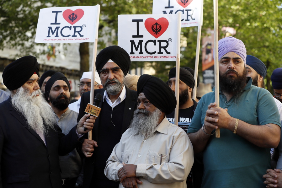 Members of the Manchester Sikh Community attend a vigil Tuesday in Albert Square, Manchester, the day after the suicide attack at an Ariana Grande concert that left 22 people dead as it ended Monday night.