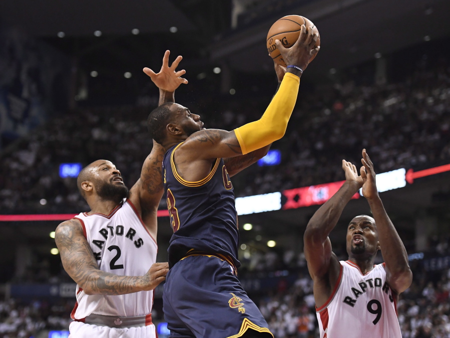 Cleveland Cavaliers forward LeBron James (23) goes to the net past Toronto Raptors forwards P.J. Tucker (2) and Serge Ibaka (9) during the second half of Game 4 of a second-round NBA basketball playoff series in Toronto, Sunday, May 7, 2017.